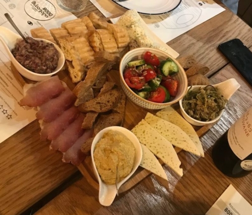 Local cheeses, veggie dips, salad, bread and cured pork